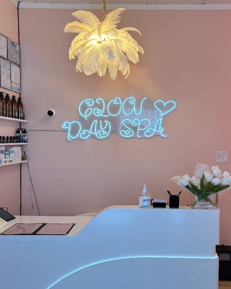 The front desk at Glow Day Spa with its glowing neon sign